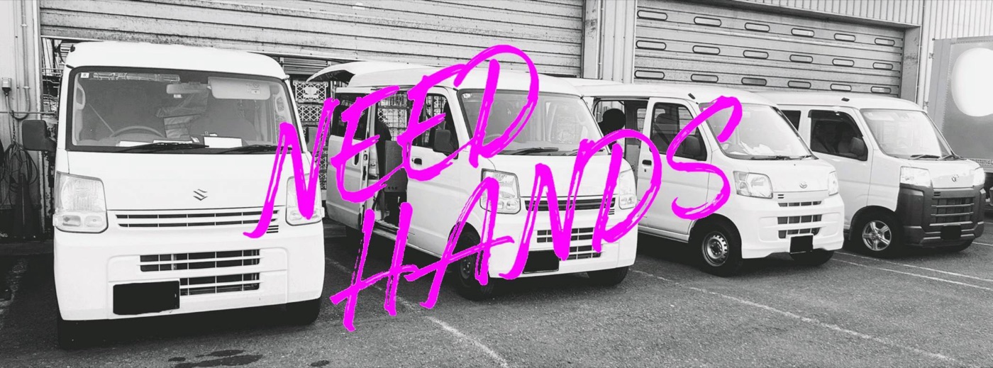 並んだ軽バンの白黒写真に、ピンクの手書きでNEED HANDS